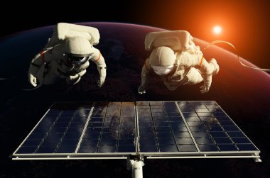 Astronotlar uzayda güneş battarei çevresinde