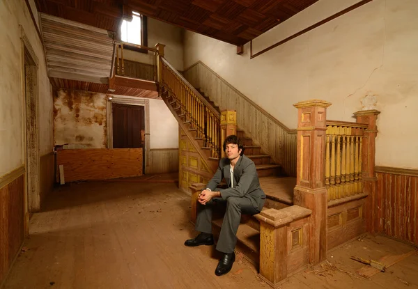 Man Sitting on Stairs in an Old House — Stock Photo, Image