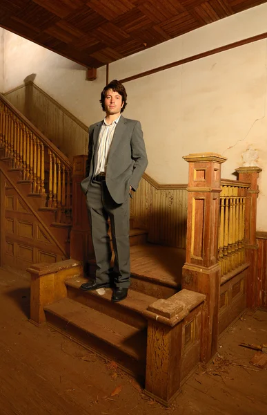 Man Sitting on Stairs in an Old House — Stock Photo, Image