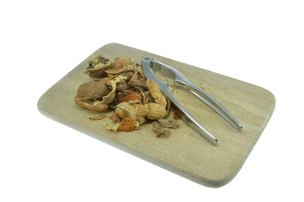Empty nut shells on a wooden board — Stock Photo, Image