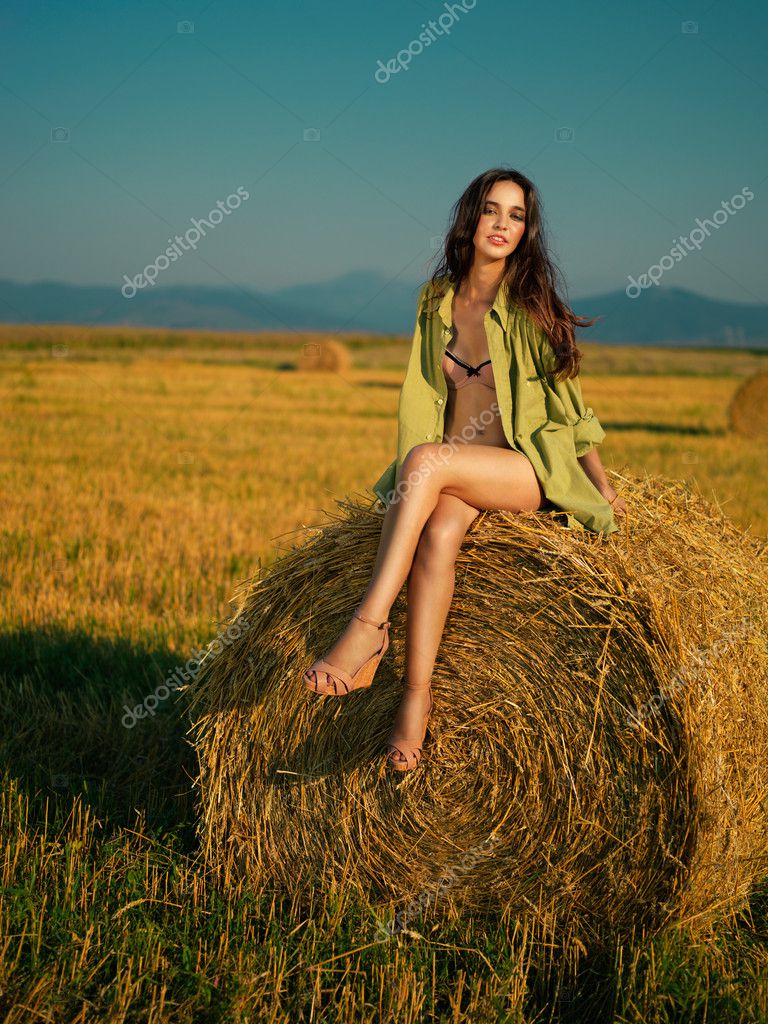 Beautiful Woman Sitting On Hay Stack Stock Photo Shotsstudio