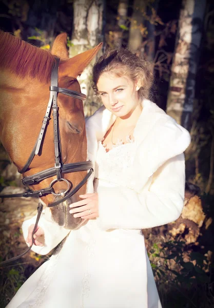 Portrait of bride with horse at forest background — Stock Photo, Image