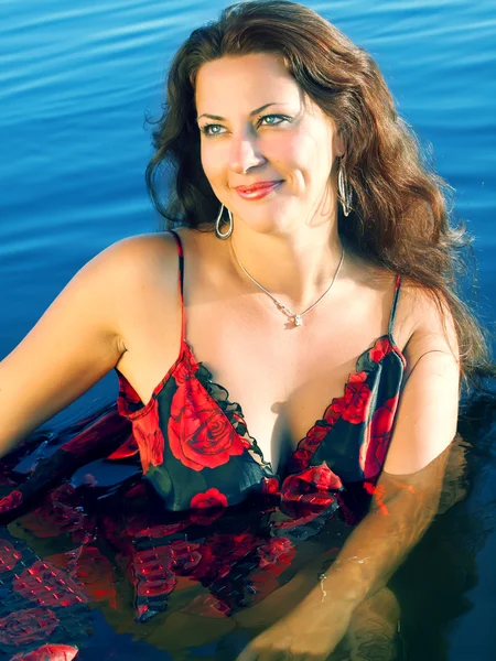 Sexual women in red in water — Stok fotoğraf