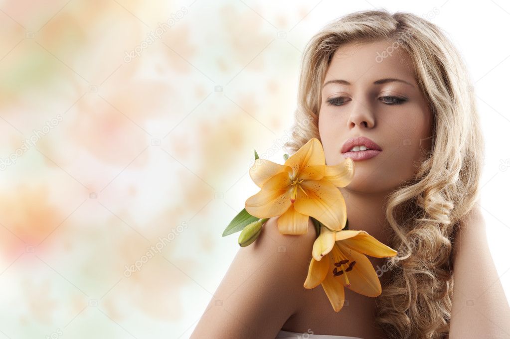 Blond curly girl with orange flower