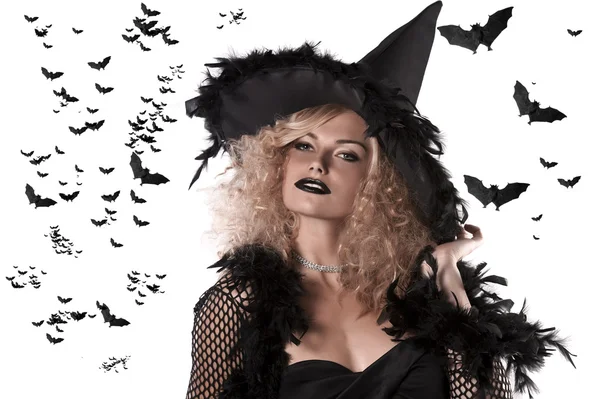 Portrait of a curly blonde wearing a huge witch hat — Stock Photo, Image