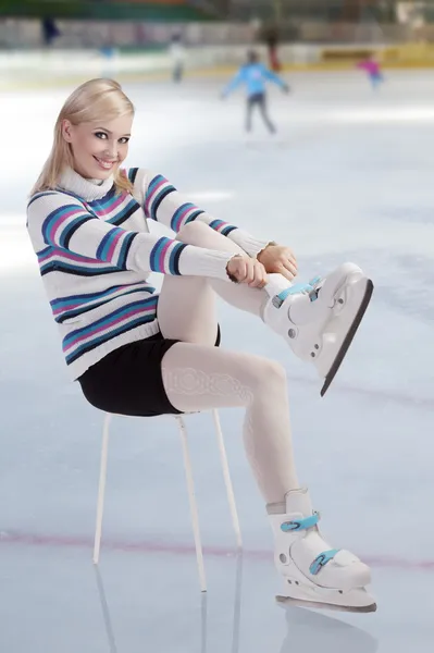 stock image Beautiful woman putting skates on