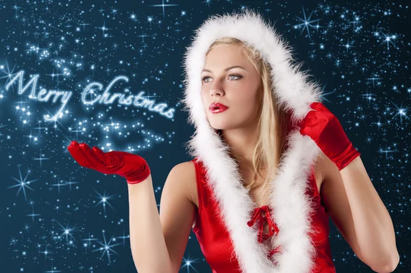 Christmas girl blowing from hand... — Stock Photo, Image