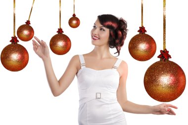 Preety girl playing between the christmas ball clipart