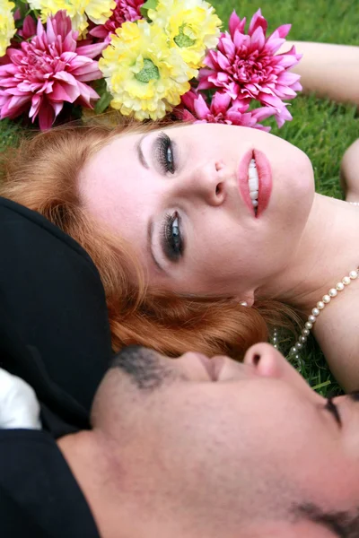 Жених и невеста лежат на траве — стоковое фото