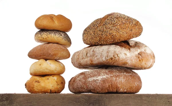 Bread loaf and buns on a shelf — Stock Photo, Image