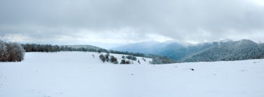 First winter snow and mountain panorama clipart