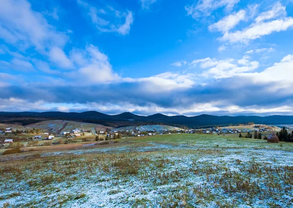 First winter snow and autumn mountain village — Stock Photo, Image