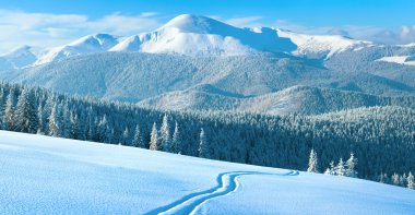 Winter mountain panorama with ski track clipart