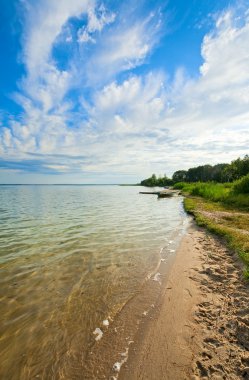 Boat near the summer lake shore clipart