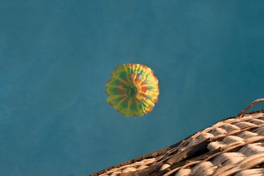 Hot air ballon flying over water clipart
