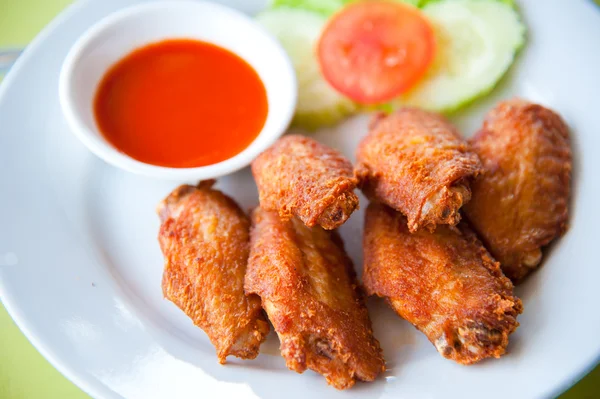 Deep fried spicy chicken wing with chili sauce - Stock Image - Everypixel