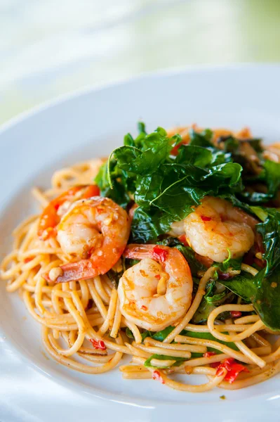 stock image Tasty hot and spicy spaghetti with cream, cheese and parsley close up