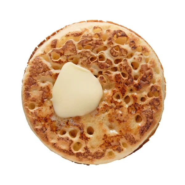Buttered crumpet, shot from the top, isolated — Stock Photo, Image