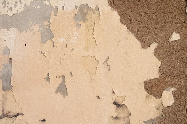 Old wall withpeeling weathered pastel paint — Stock Photo, Image