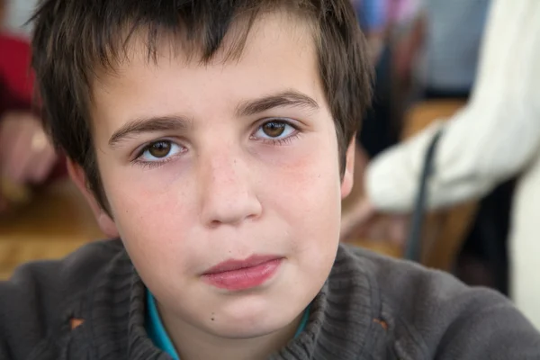 Young boy trying not to smile — Stock Photo, Image