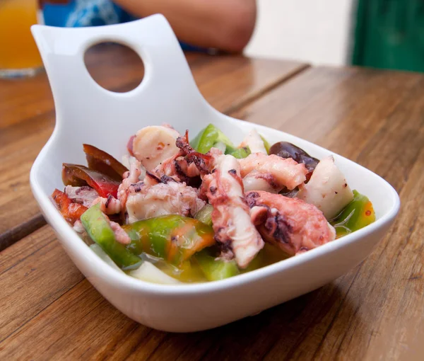 Portion of octopus salad on a wooden table — Stock Photo, Image