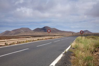 Travelling inland on Fuerteventura, lolcanic landscape, malpais clipart