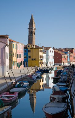 Burano island in lagoon of Venice; famous brightly-colored house clipart