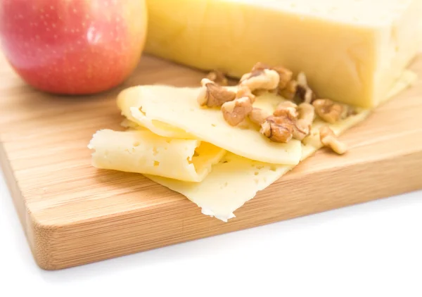 stock image Healthy snack - slices of cheese, walnut and red apple presented on a woode