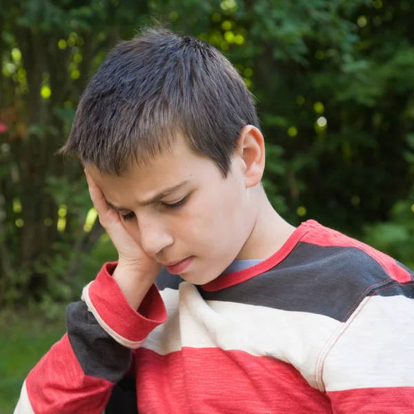 Thoughtful pre-teen boy outdoors — Stock Photo, Image