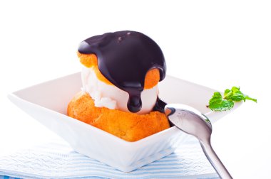 Profiterole in a small bowl with ice cream chocolate sauce and m clipart