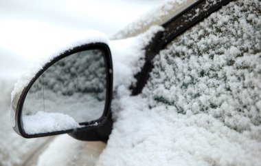 Cars parked on a city street covered with snow after a heavy sno clipart