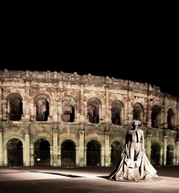 Statue of famous bullfighter in front of the arena in Nimes, France. clipart