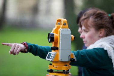 Young land surveyor at work clipart