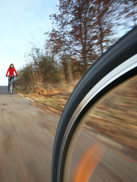 Biking (the image is motion blurred to convey movement; focus i — Stock Photo, Image