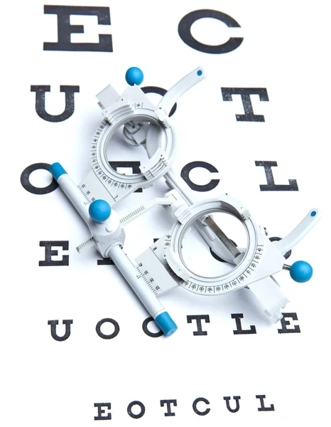 Optometry concept - sight measuring spectacles & eye chart — Stock Photo, Image