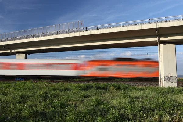 Fast train passing under a bridge — Stock Photo, Image