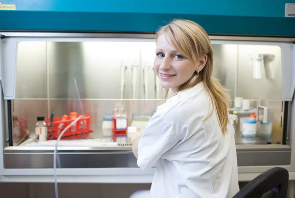 Portrait of a female researcher doing research in a lab (color t — Stock Photo, Image