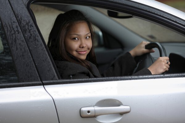 Young woman driving her new car.
