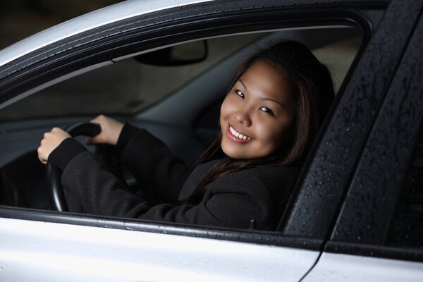 Young woman driving her new car.