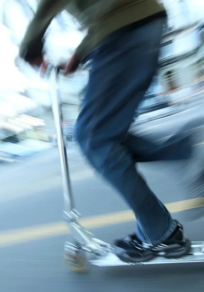 Boy on a scooter going fast (panning technique used -> motion bl — Stock Photo, Image