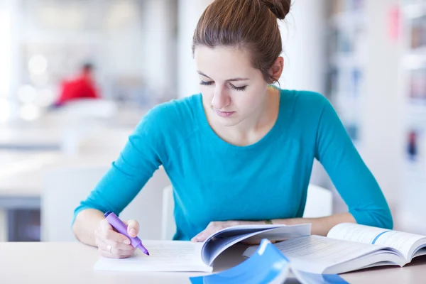 Pretty young college student in a library Stock Photo
