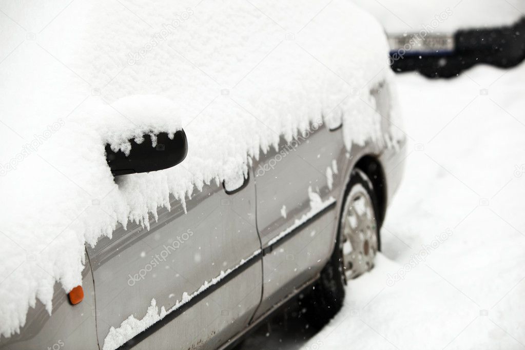 Cars covered with snow after a heavy snowfall in a city