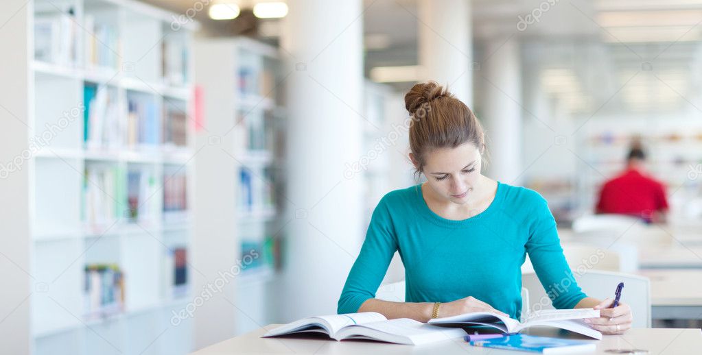 Pretty young college student in a library