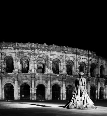 Statue of famous bullfighter in front of the arena in Nimes, France. clipart