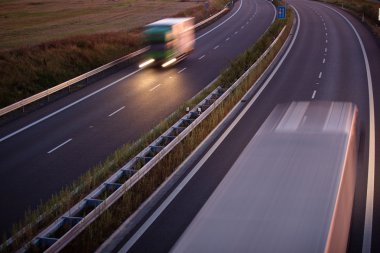 Highway traffic - motion blurred truck on a highway clipart