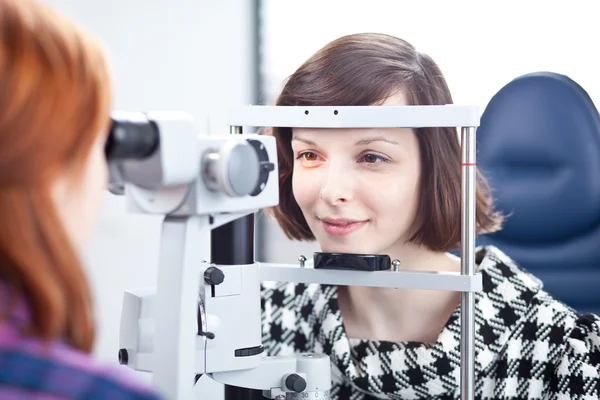 Concetto di optometria - bella giovane donna che si fa esaminare gli occhi — Foto Stock