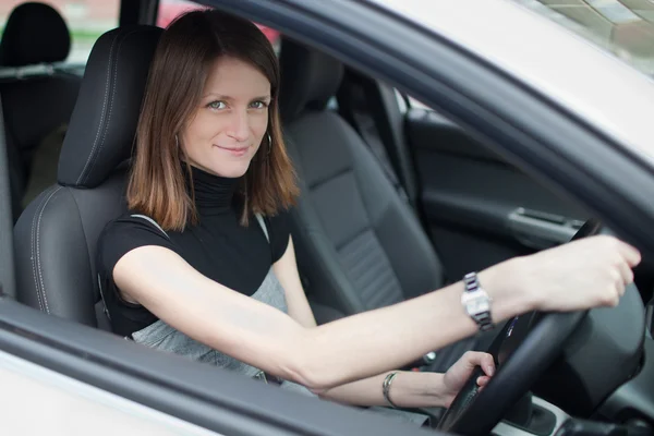 Αρκετά νεαρή γυναίκα οδήγηση αυτοκινήτου της νέα — Φωτογραφία Αρχείου