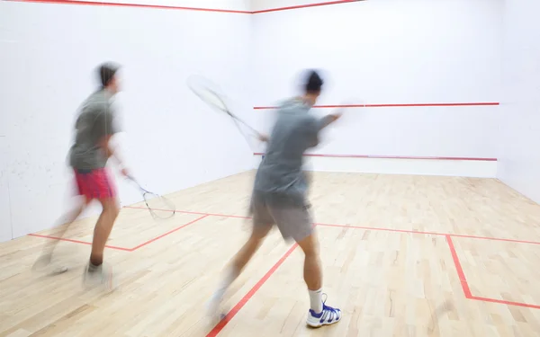 Squash spelers in actie op een squashbaan (beweging wazig beeld — Stockfoto