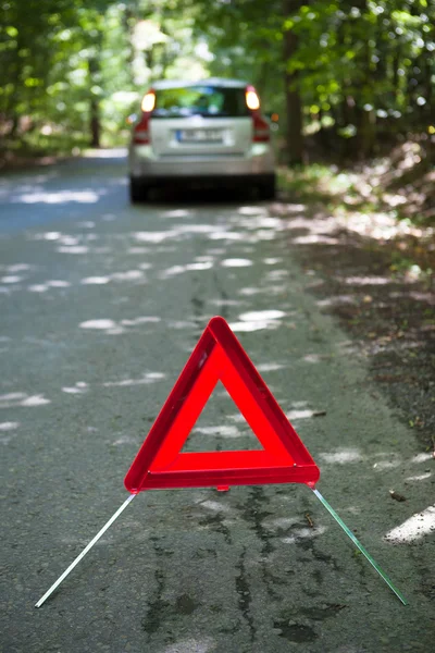 Розбитий автомобіль з попереджувальним трикутником — стокове фото