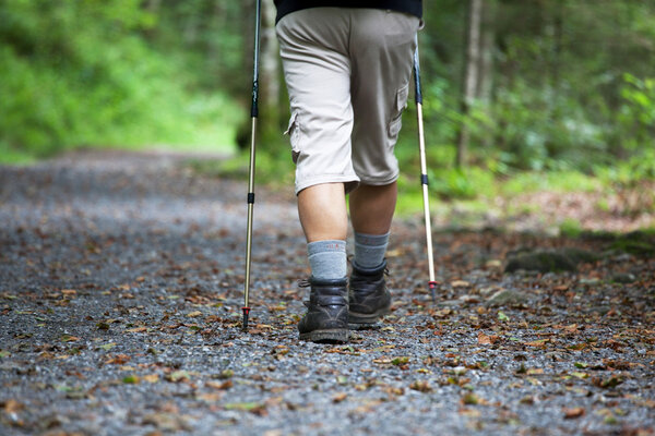 Active handsome senior man nordic walking outdoors